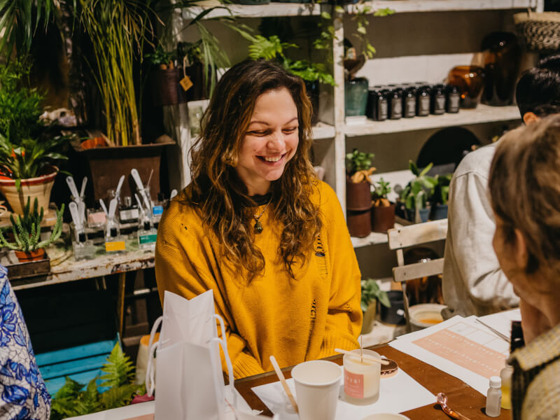 woman smiling at candle making class